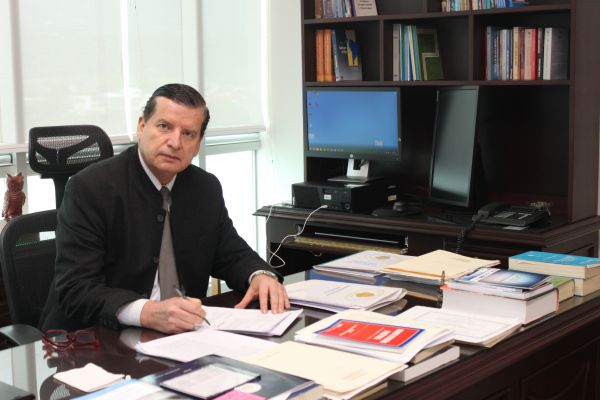 Magistrado Jorge Araya García, sentado en la oficina , posa para la fotografía 